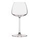 A clear wine glass with a long stem.