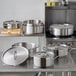 A stainless steel Vigor brazier on a stove in a professional kitchen.