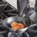 A Vigor stainless steel fry pan with scallops cooking.