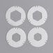 A group of four white circular plastic pieces.