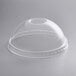 A clear plastic dome lid on a clear plastic cup.