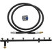 A black hose and metal tube in a Crown Verity liquid propane to natural gas conversion kit.