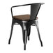 A Lancaster Table & Seating black metal chair with a walnut wood seat.