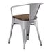 A Lancaster Table & Seating gray metal arm chair with a walnut wood seat.