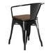 A Lancaster Table & Seating black metal chair with a walnut wood seat.