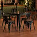 A Lancaster Table and Chairs with Walnut Seats on a Table in a Restaurant