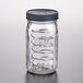 A Ball wide mouth glass jar with a black metal lid.