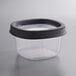 A Ball clear plastic freezer jar with a black lid.