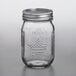 A Ball glass canning jar with a silver lid.