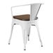 A white metal Lancaster Table & Seating chair with a walnut wood seat.