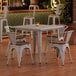 A Lancaster Table & Seating nickel gray table and chairs with walnut seats.