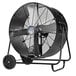 A large black TPI industrial drum fan on wheels.