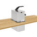 A Nemco stainless steel drop-in pump dispenser on a wooden table.