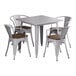 A nickel gray Lancaster Table & Seating square table with walnut wood seats and four arm chairs.