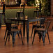 A Lancaster Table and Chairs set with black and walnut finishes in a restaurant dining area.