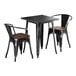 A Lancaster Table & Seating black metal table with two chairs with walnut seats.