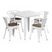A white Lancaster Table & Seating square table with white metal chairs.