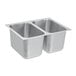 A silver metal Vollrath sink with two compartments.