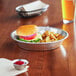 A Baker's Mark aluminum pie pan filled with a slice of pie on a plate.