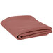 A folded mauve Intedge cloth table cover.