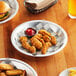 close-up of fried chicken strips and french fries on a plate