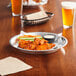 A Baker's Mark aluminum pie pan filled with a chicken and vegetable pie on a table.