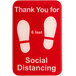 a red sign with white footprints