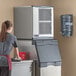 A woman cleaning a Scotsman air cooled flake ice machine.