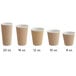 A row of Choice brown double wall ripple paper cups with a white rim.
