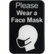 A black and white plastic sign with the words "Please Wear a Face Mask" above a white silhouette of a head with a face mask.