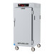 A white metal Metro C5 reach-in holding cabinet with wheels.