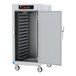A white metal Metro C5 heated holding cabinet with wheels and a door open.