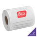 A roll of white TamperSafe paper labels with red customizable labels on it.