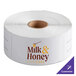 A roll of white TamperSafe paper labels with customizable text.