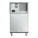 The back of a white Manitowoc Indigo NXT air cooled ice machine with a metal frame.