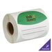 A roll of TamperSafe green paper labels with white writing.