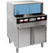 A CMA Dishmachines undercounter glass washer on a counter with blue paper on top.