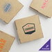 A group of Choice kraft corrugated pizza boxes with logos on them.