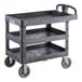 A Lavex black plastic utility cart with three shelves.