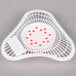 A white plastic basket with red dots.