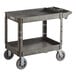 A Lavex black plastic utility cart with two shelves and oversized wheels.