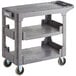A grey Lavex plastic utility cart with three shelves and wheels.