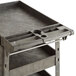 A black plastic utility cart with shelves and tool compartments.