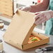 A person in gloves opening a Choice kraft pizza box.
