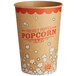 A brown and red Carnival King paper cup with popcorn on it.