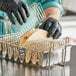 a person holding a metal basket with tortillas