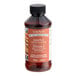 A bottle of LorAnn Oils Maple Bakery Emulsion on a table with a black cap.