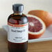 A bottle of LorAnn Oils Blood Orange Super Strength Flavor on a counter.