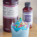 A cupcake with blue frosting and sprinkles with LorAnn Oils Princess Cake and Cookie Bakery Emulsion.