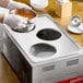 A person using a Choice 3 Hole Steam Table Adapter Plate to serve soup in bowls.